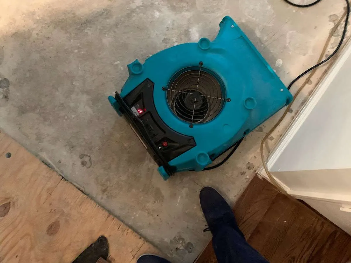 Air mover drying subfloor during Commercial Water Damage Restoration in St. Augustine Shores